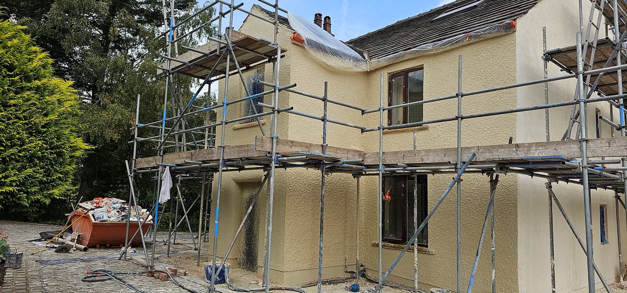 Lime render restoration work on a scaffolded property